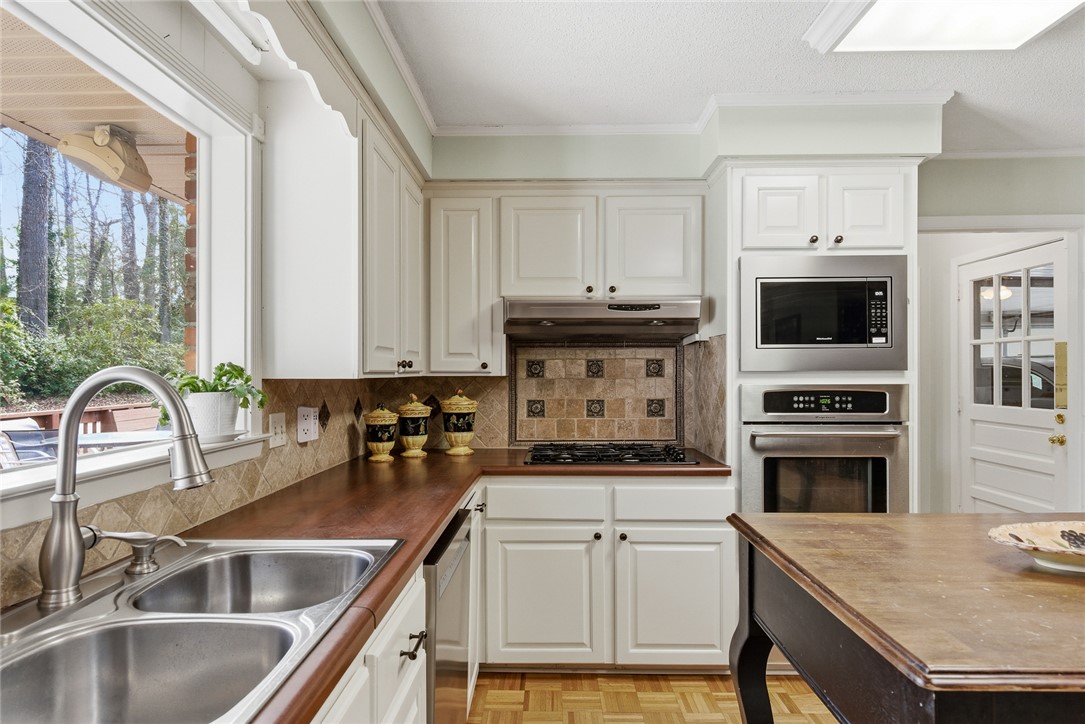 106 Cherokee Circle Anderson, SC 29621 - Photo 16 of 47 This spacious kitchen offers ample countertop space and a picturesque window view of lush greenery.