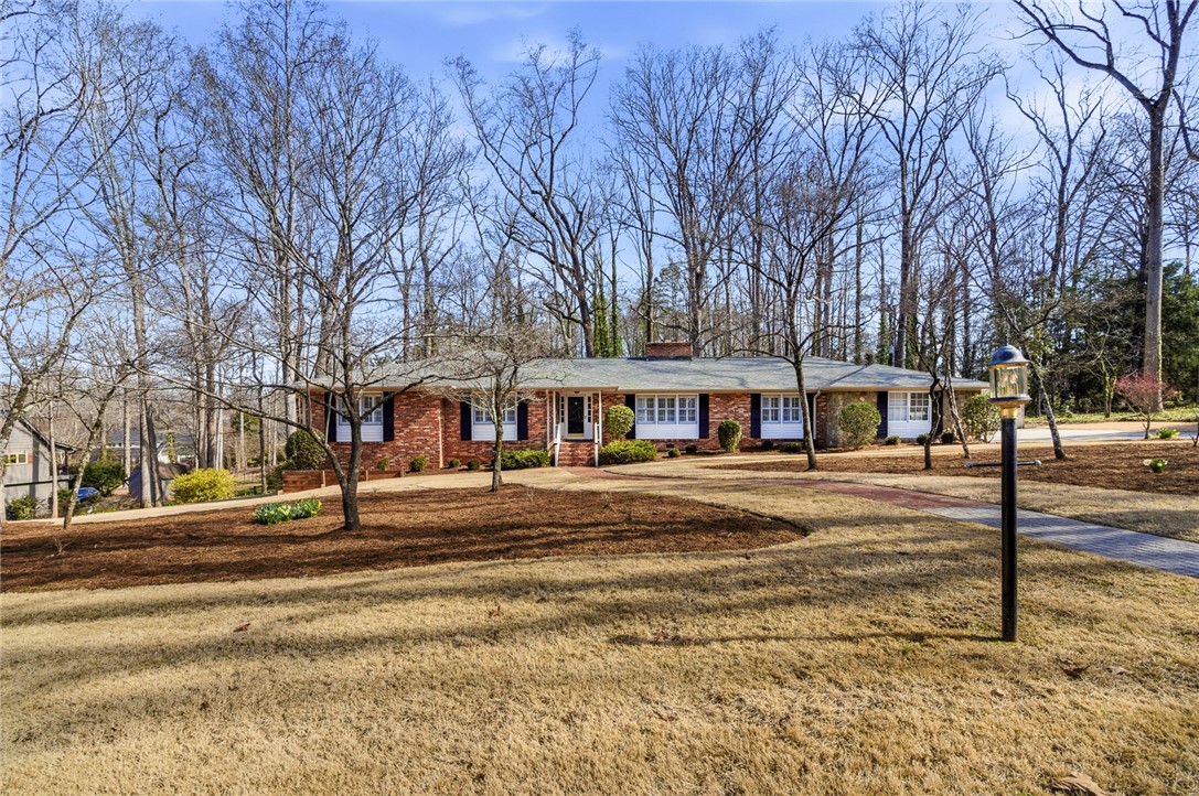 106 Cherokee Circle Anderson, SC 29621 - Photo 2 of 47 A classic brick ranch home sits gracefully among mature trees and a manicured lawn.