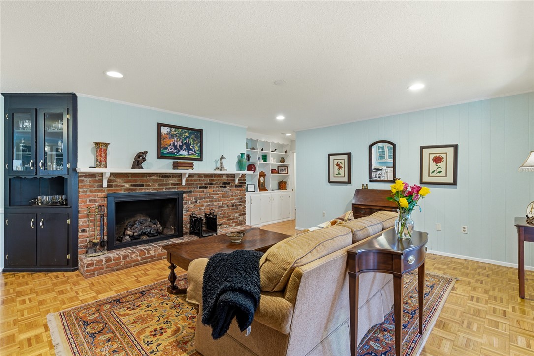 106 Cherokee Circle Anderson, SC 29621 - Photo 21 of 47 This inviting living room features a brick fireplace and built-in shelving, creating a cozy and functional space.
