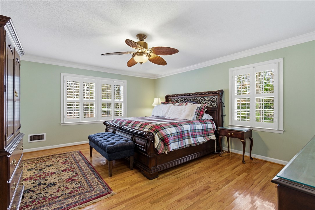 106 Cherokee Circle Anderson, SC 29621 - Photo 25 of 47 This spacious bedroom features ample natural light and elegant hardwood floors.
