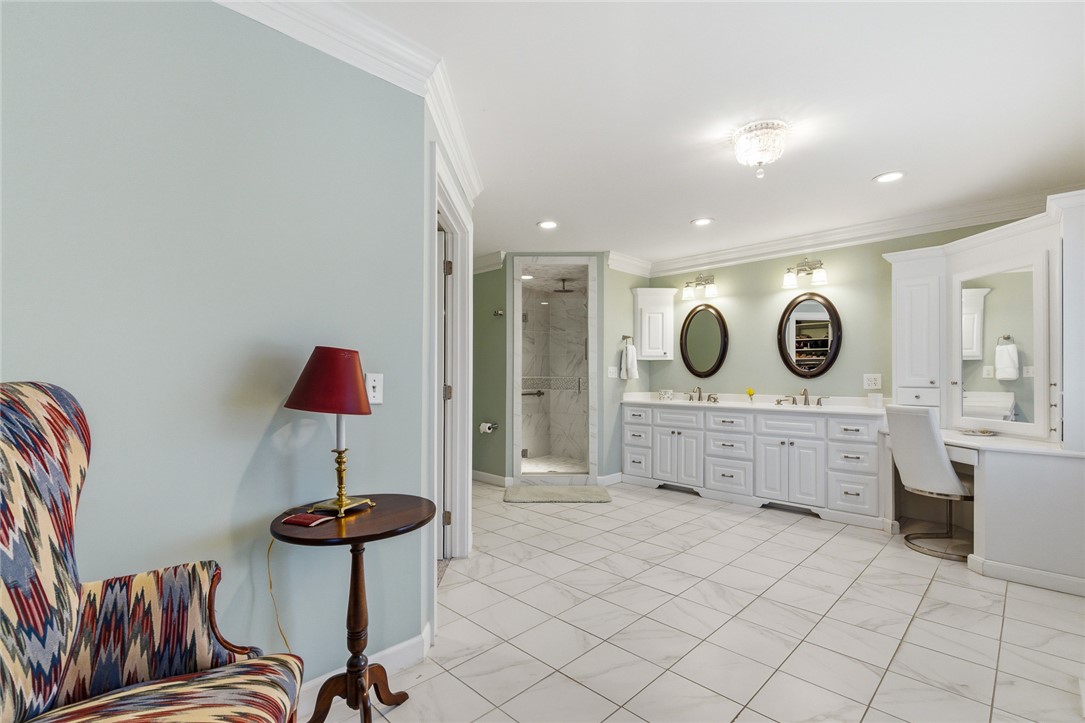 106 Cherokee Circle Anderson, SC 29621 - Photo 28 of 47 This spacious bathroom offers elegant dual vanities and a modern glass-enclosed shower.