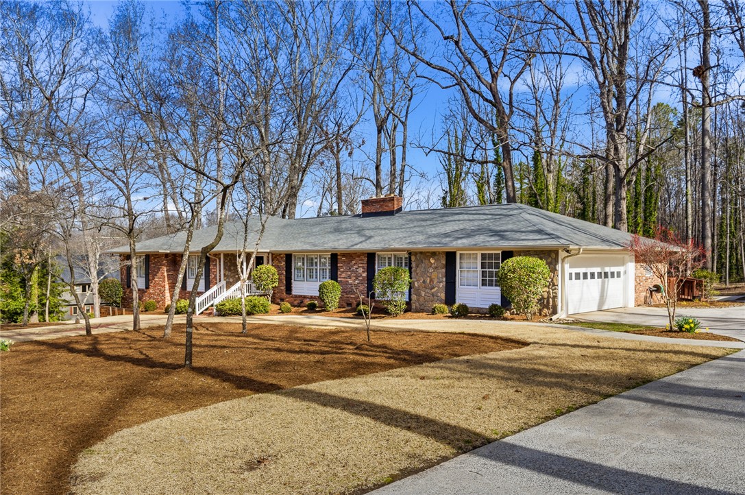 106 Cherokee Circle Anderson, SC 29621 - Photo 3 of 47 An inviting ranch-style home featuring a blend of brick and stone, set amidst mature trees.
