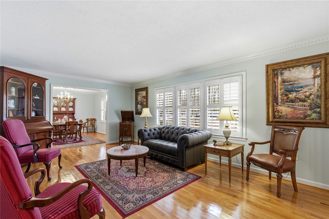 106 Cherokee Circle Anderson, SC 29621 - Photo 8 of 47 This inviting living space features gleaming hardwood floors and ample natural light, flowing seamlessly into the dining area.