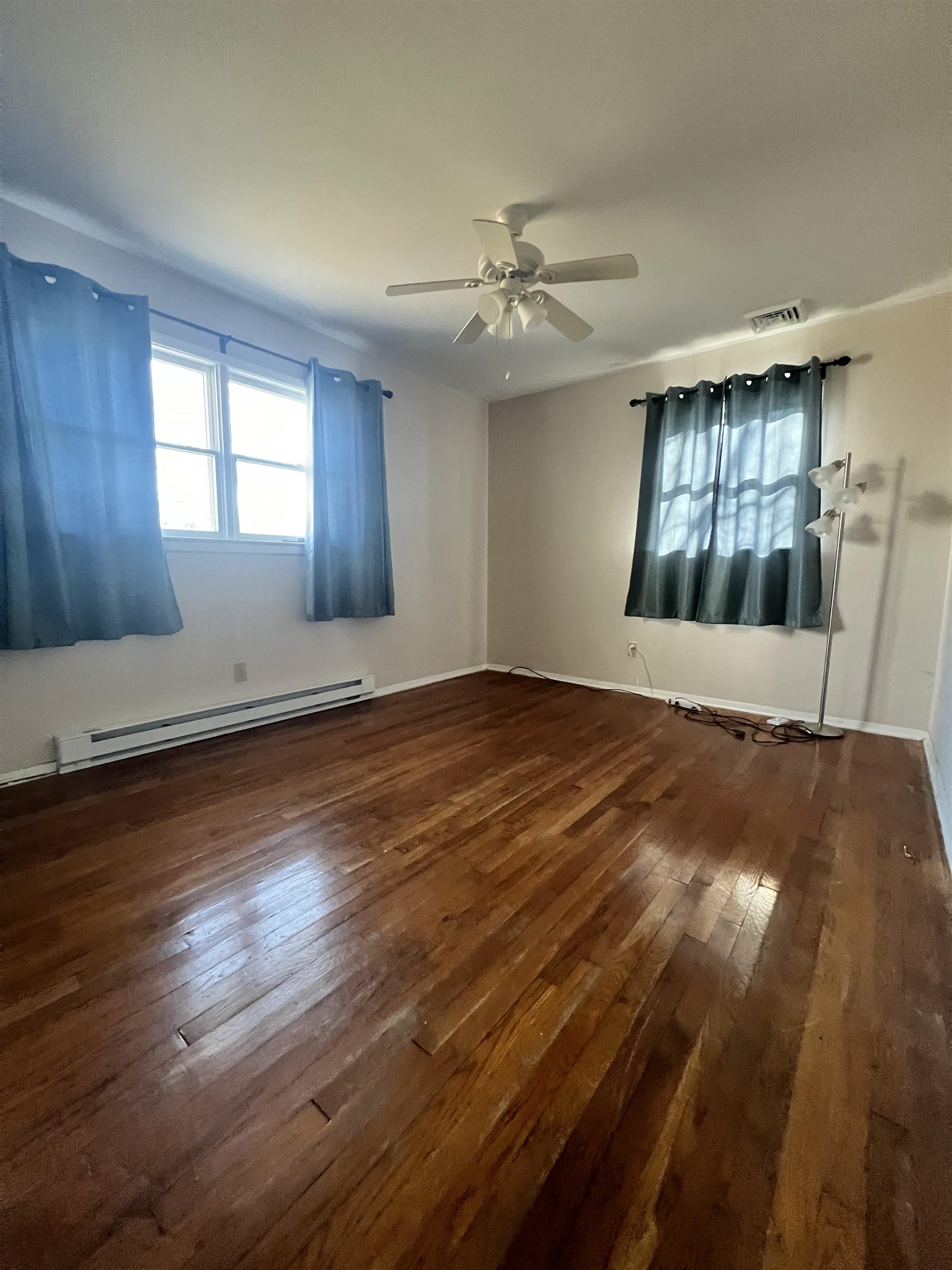 116 Kenvil Road North Cape May, NJ 08204 - Photo 8 of 16 a view of an empty room with window and wooden floor