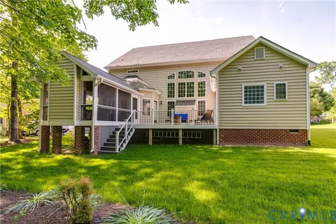 a view of a house with a yard and sitting area