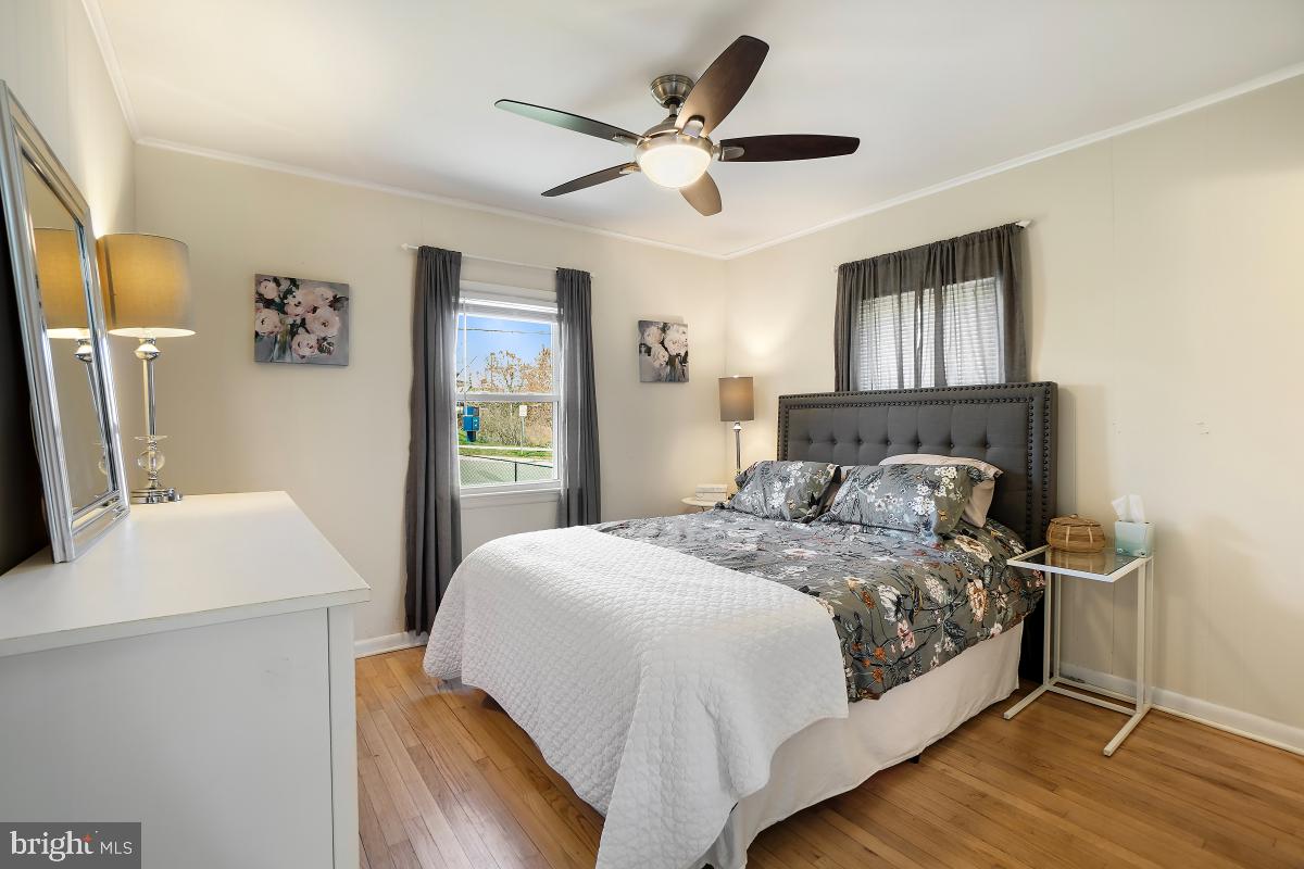 4206 Dahill Road Silver Spring, MD 20906 - Photo 19 of 33 a bedroom with a large bed and a chandelier