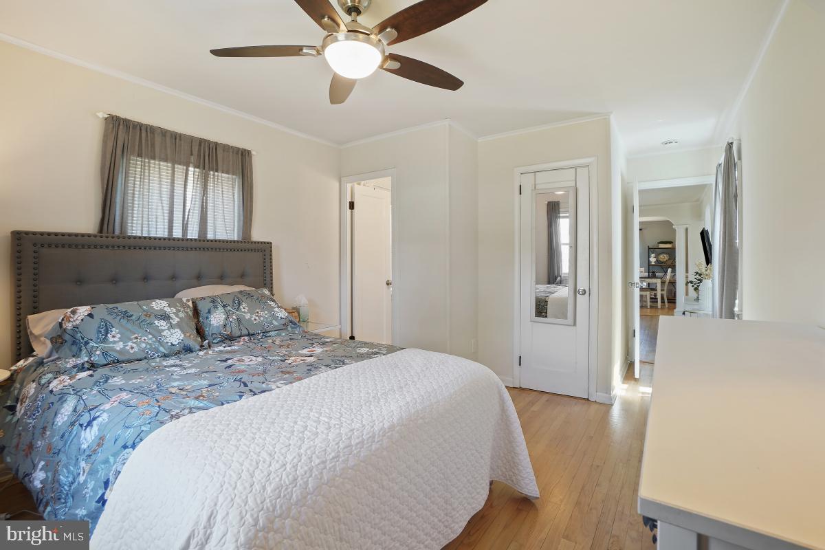 4206 Dahill Road Silver Spring, MD 20906 - Photo 20 of 33 a bedroom with a large bed and a chandelier