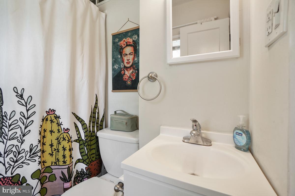 4206 Dahill Road Silver Spring, MD 20906 - Photo 22 of 33 a bathroom with a sink mirror and toilet