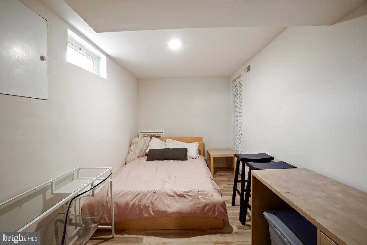 4206 Dahill Road Silver Spring, MD 20906 - Photo 29 of 33 a bedroom with a bed and a table in it