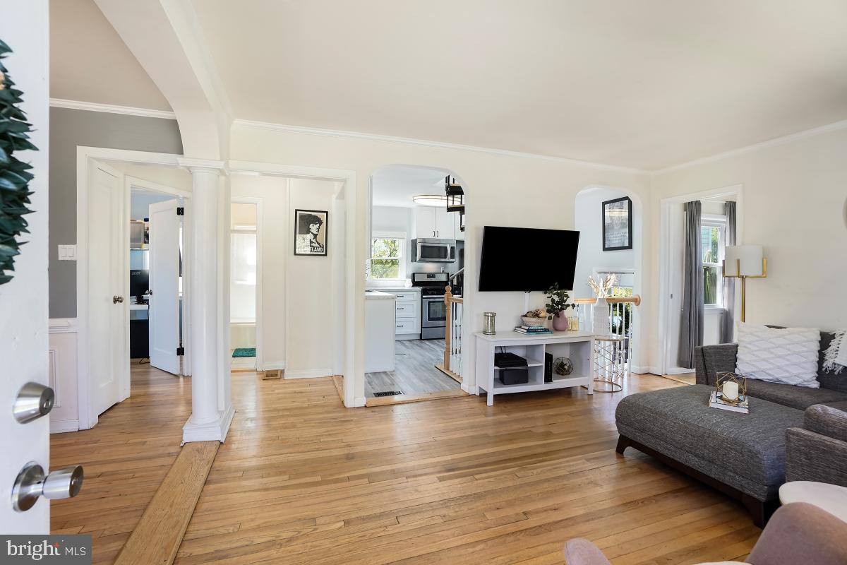 4206 Dahill Road Silver Spring, MD 20906 - Photo 6 of 33 a living room with furniture flat screen tv and wooden floor