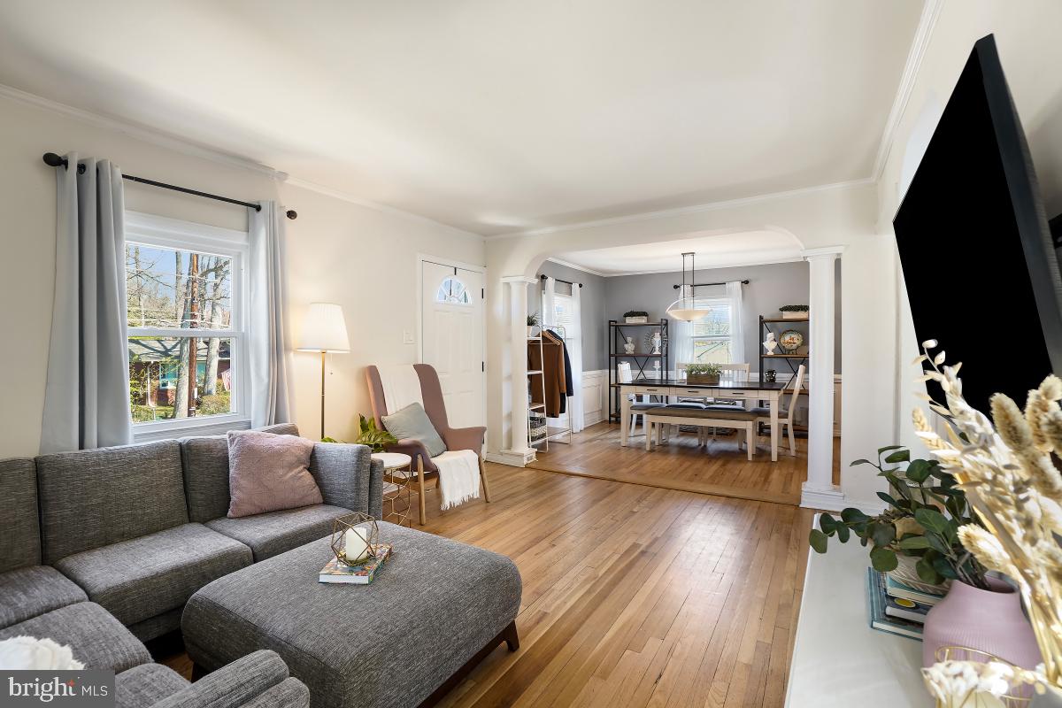 4206 Dahill Road Silver Spring, MD 20906 - Photo 7 of 33 a living room with furniture flat screen tv and wooden floor