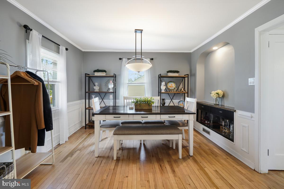 4206 Dahill Road Silver Spring, MD 20906 - Photo 8 of 33 a living room with furniture a fireplace and a chandelier
