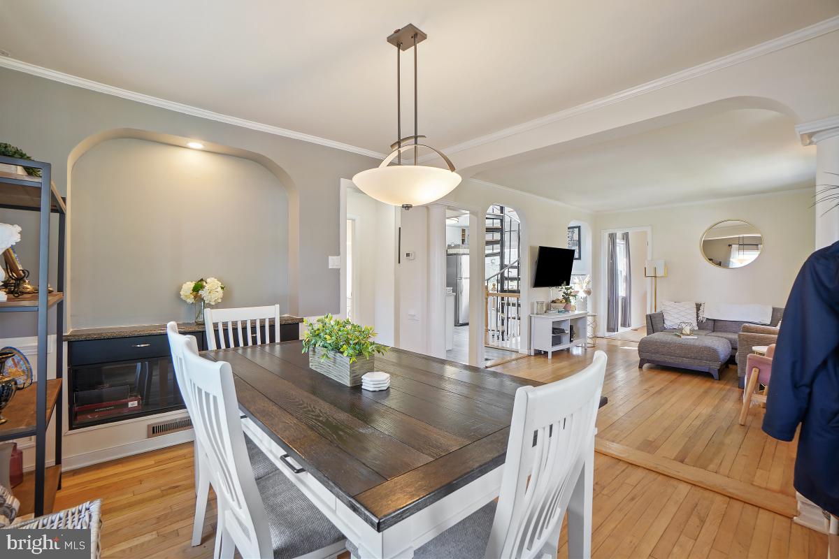 4206 Dahill Road Silver Spring, MD 20906 - Photo 10 of 33 a view of a dining room with furniture a chandelier and wooden floor