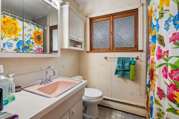a bathroom with a sink mirror vanity and toilet