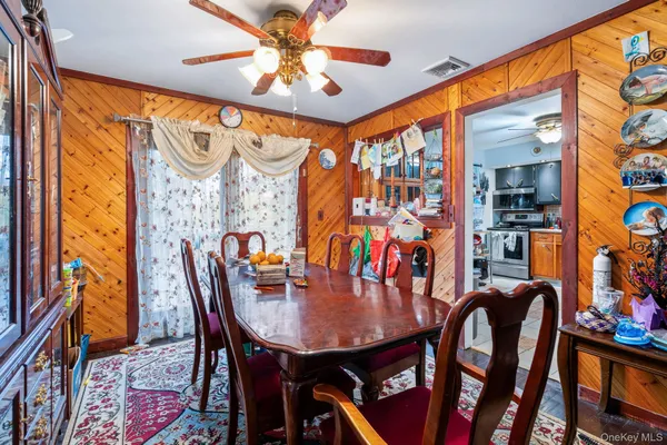 a view of a dining room with furniture and a chandelier
