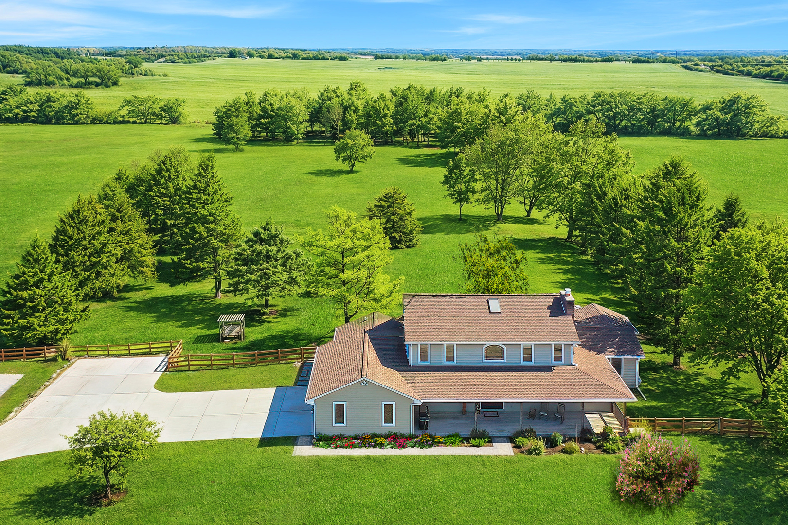 an aerial view of a house with a yard and lake view