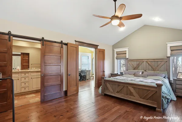 a bedroom with a bed and a chandelier