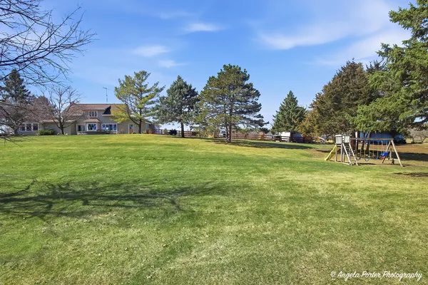 a view of a field with trees in the background