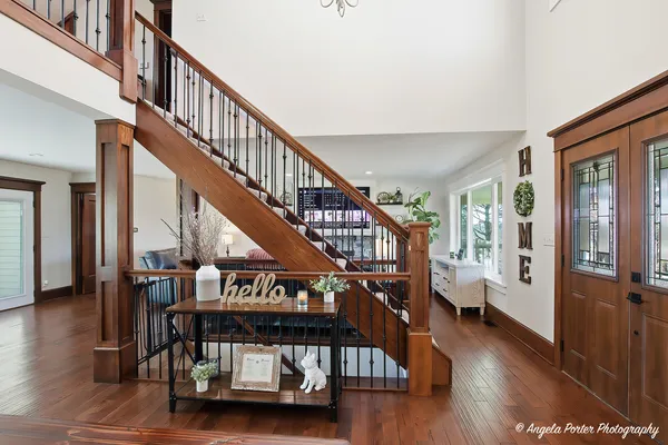 a view of entryway livingroom and hall with wooden floor