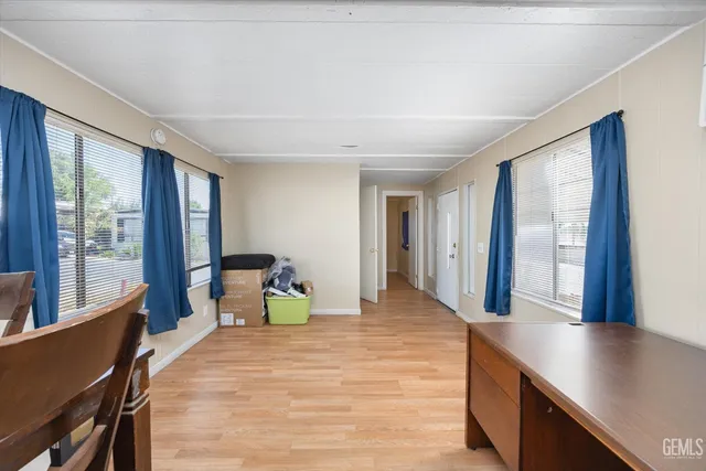 a bedroom with a large bed and large windows