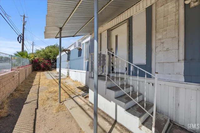 a view of balcony with wooden floor and potted plants