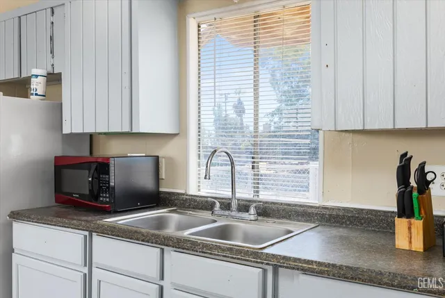 a kitchen with granite countertop a sink and a window