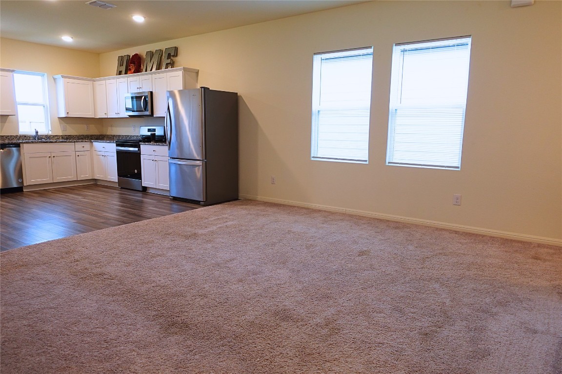 402 Plateau Street Maxwell, TX 78656 - Photo 7 of 18 a kitchen with stainless steel appliances a refrigerator and a stove top oven