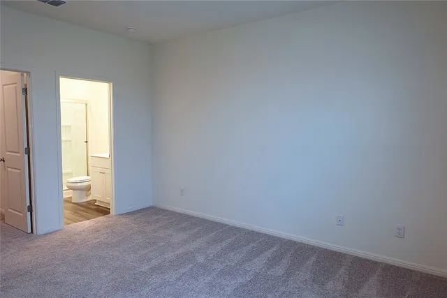 a view of an empty room and a window