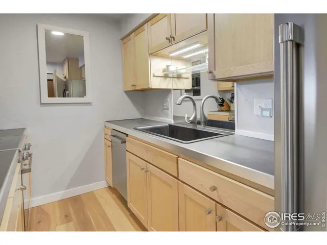 a kitchen with a sink cabinets and a window