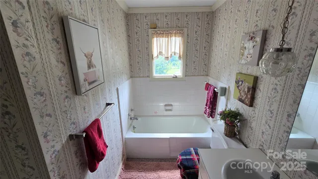 a bathroom with a tub sink and a mirror