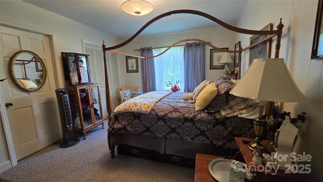 a bedroom with a bed a mirror and dresser