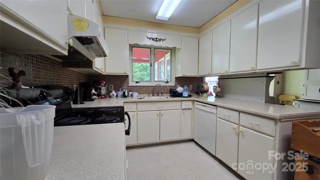 a kitchen with a sink cabinets and window