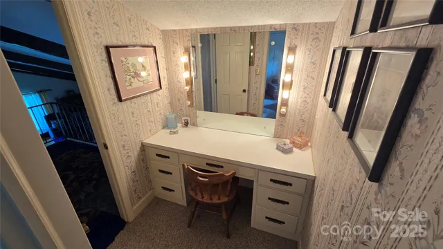 a bathroom with a sink a mirror a vanity and a shower