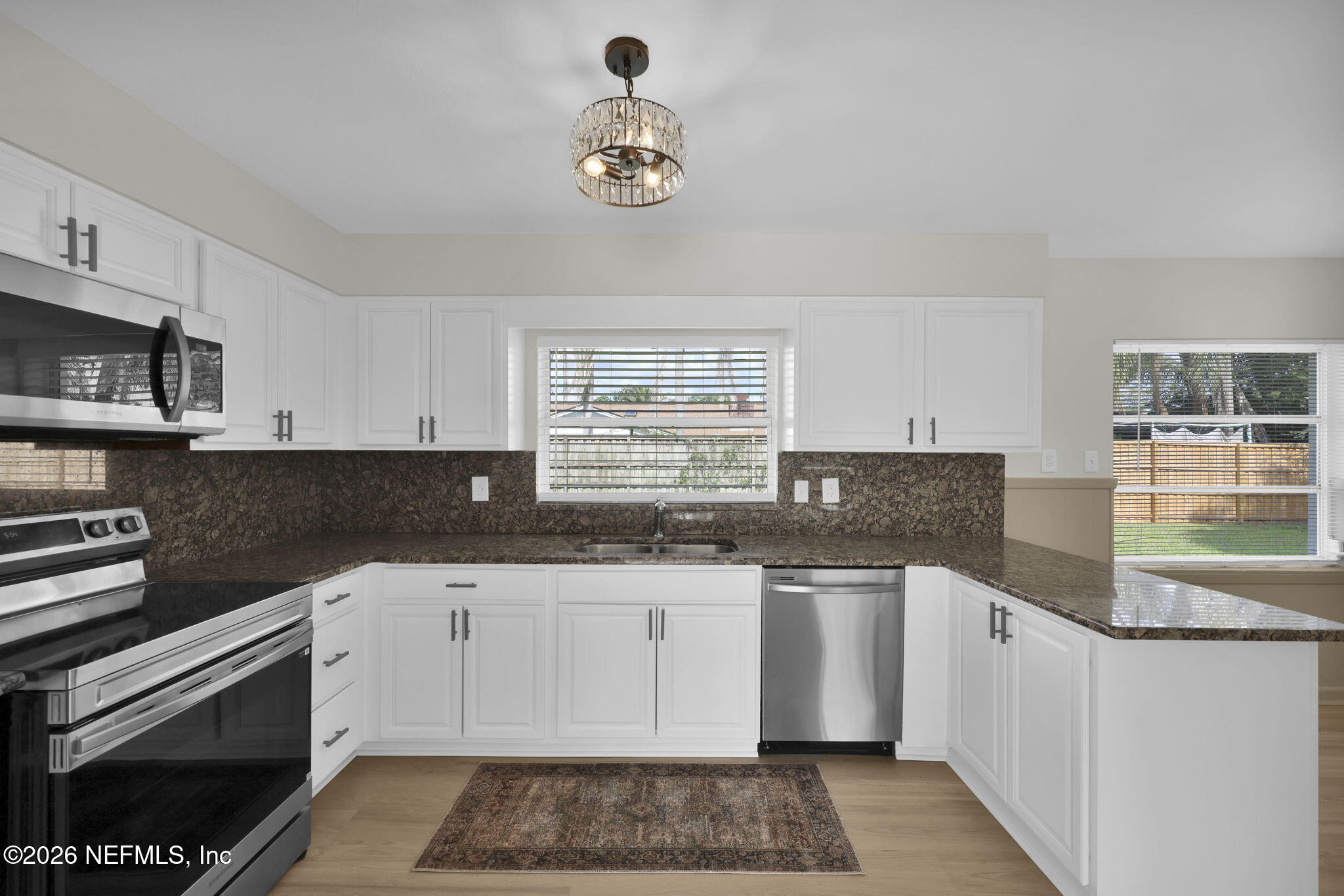 8544 Sanchez Road Jacksonville, FL 32217 - Photo 27 of 46 a kitchen with stainless steel appliances granite countertop a sink and cabinets