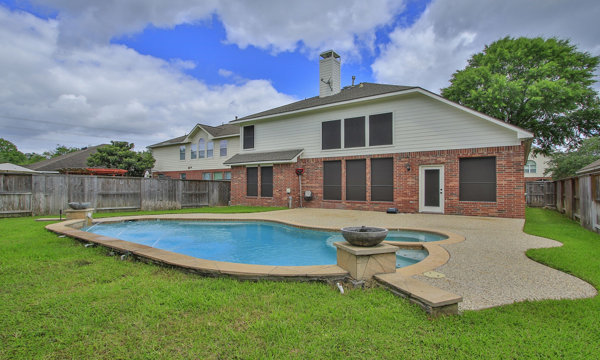 1210 Berwick Manor Court Spring, TX 77379 - Photo 46 of 50 a view of a house with swimming pool and a yard