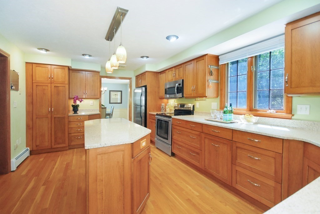 22 Taylor Road Stow, MA 01775 - Photo 11 of 32 a large kitchen with granite countertop a large counter top stainless steel appliances and cabinets