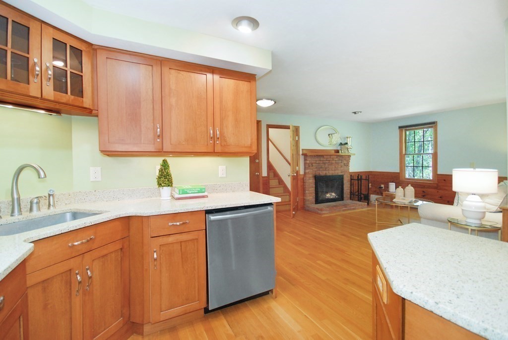 22 Taylor Road Stow, MA 01775 - Photo 12 of 32 a kitchen with stainless steel appliances granite countertop a sink dishwasher stove top oven and cabinets with wooden floor
