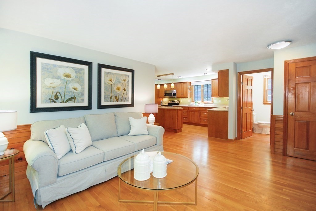 22 Taylor Road Stow, MA 01775 - Photo 14 of 32 a living room with furniture and a dining table with wooden floor