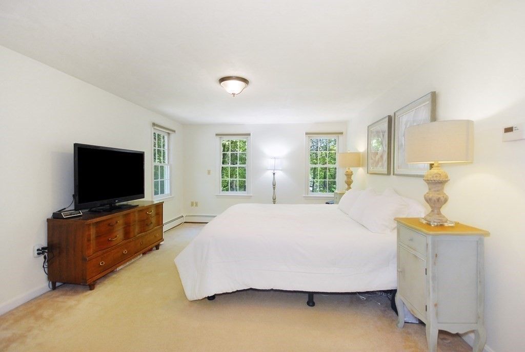 22 Taylor Road Stow, MA 01775 - Photo 16 of 32 a bedroom with a bed and a flat screen television