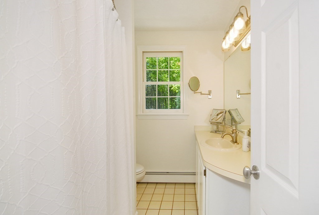 22 Taylor Road Stow, MA 01775 - Photo 17 of 32 a bathroom with a sink and a mirror