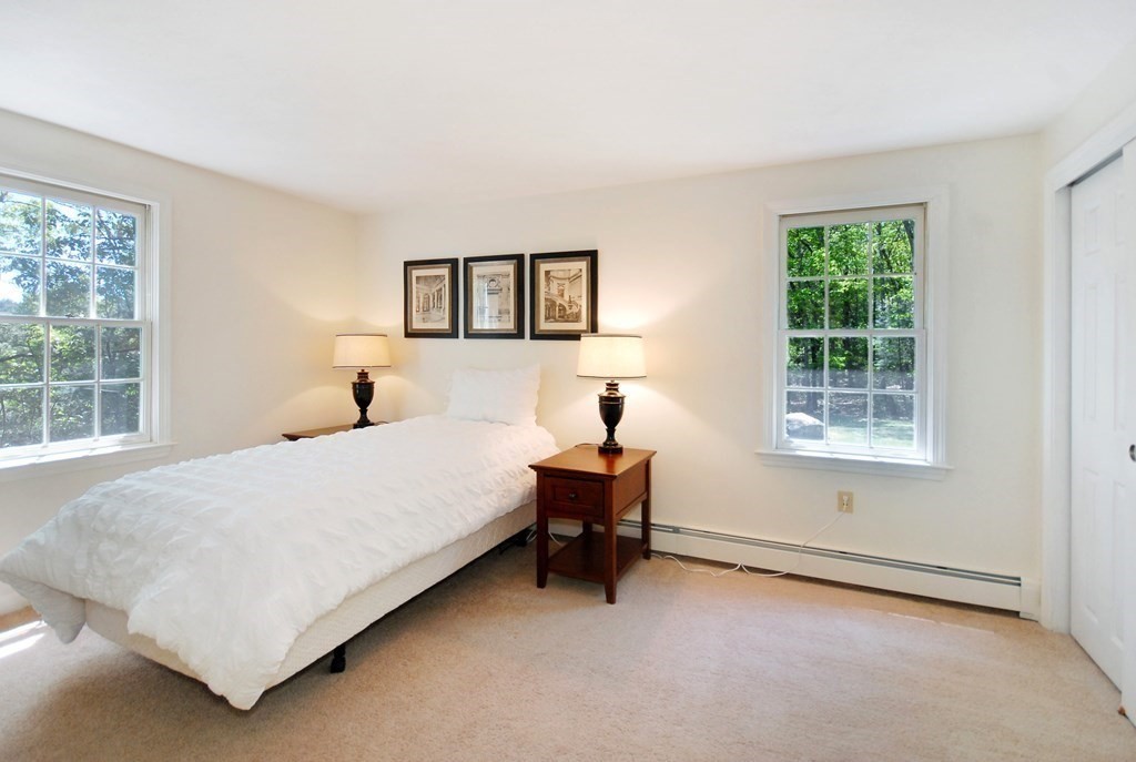 22 Taylor Road Stow, MA 01775 - Photo 18 of 32 a bedroom with a bed and a window