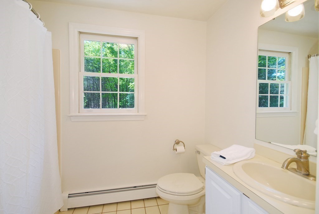 22 Taylor Road Stow, MA 01775 - Photo 21 of 32 a bathroom with a sink toilet and window