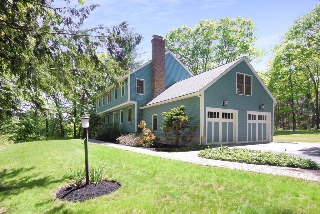 22 Taylor Road Stow, MA 01775 - Photo 26 of 32 a front view of a house with a yard and garage