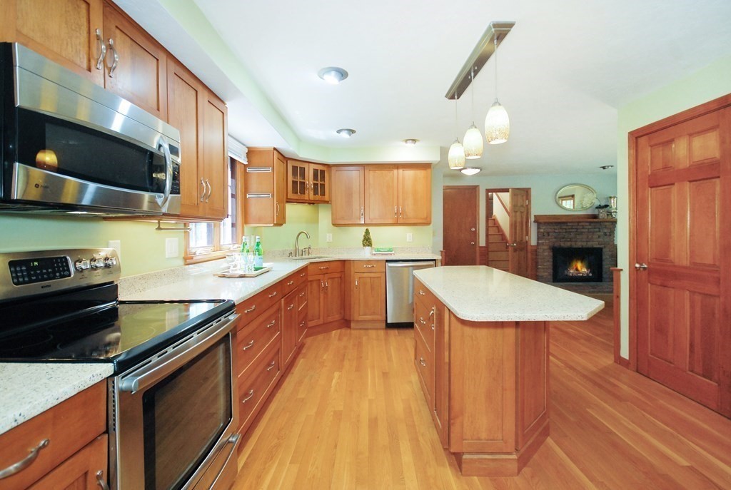 22 Taylor Road Stow, MA 01775 - Photo 8 of 32 a kitchen with stainless steel appliances granite countertop a sink a stove and a wooden floors