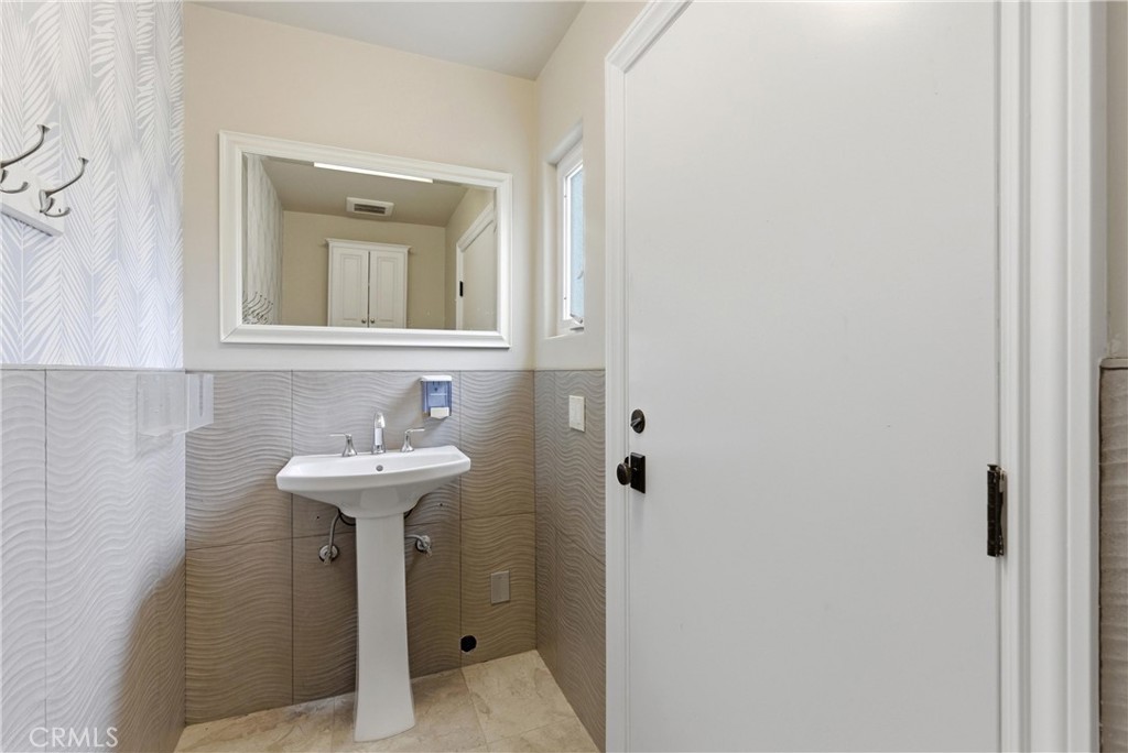 29131 Bouquet Canyon Road Silverado, CA 92676 - Photo 35 of 74 a bathroom with a sink a toilet and mirror