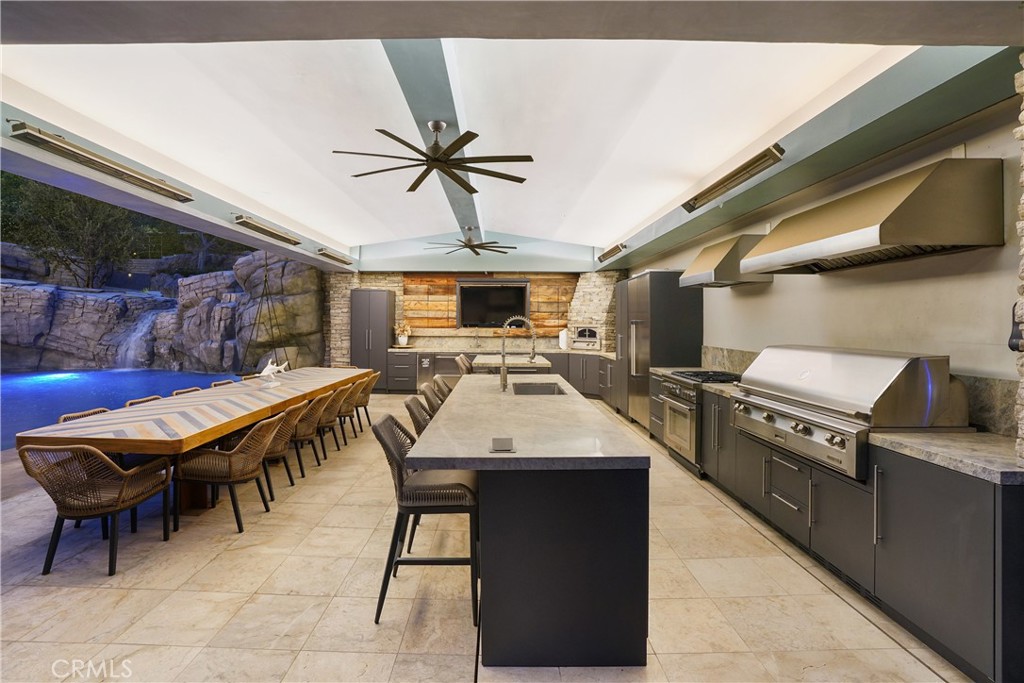 29131 Bouquet Canyon Road Silverado, CA 92676 - Photo 10 of 74 Kitchen with BBQ, smoker, pizza oven sink, dishwasher, full size refrigerator 2 drawer fridge, ice maker TV, and large island