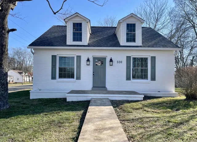 a front view of a house with garden