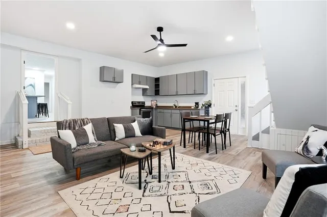 a living room with furniture and kitchen view