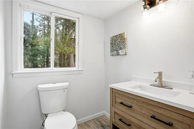 a bathroom with a toilet a sink and a window
