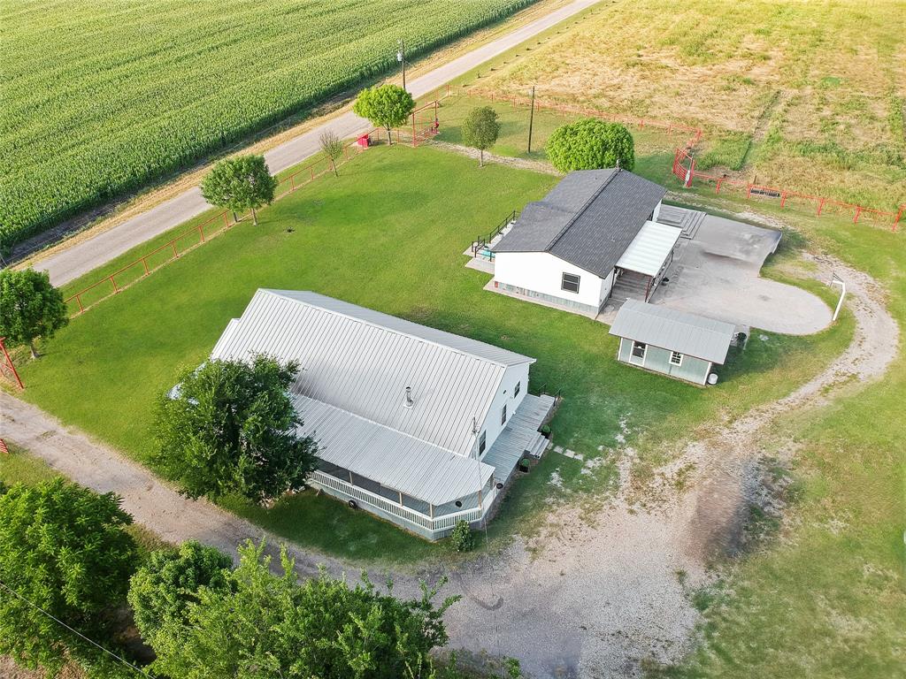 455 Hughes Cemetery Road Italy, TX 76651 - Photo 3 of 40 an aerial view of a house with a garden and swimming pool